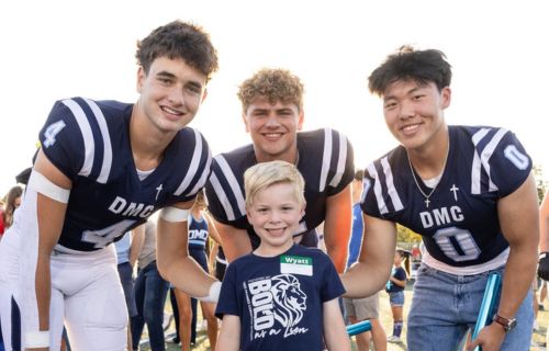 football players with elementary student